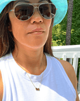 Product lifestyle picture for the Heart and Baseball charm necklace in gold with white shirt