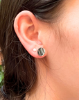 Lifestyle image of cute minimalist baseball stud earrings closeup. Lifestyle image of softball stud earrings closeup.