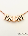 Closeup product picture of MOM baseball charm necklace in rose gold