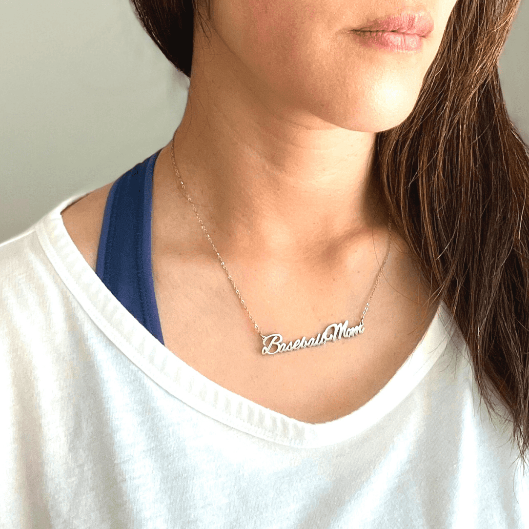 "Baseball Mom" necklace product picture in silver on a woman in white t-shirt