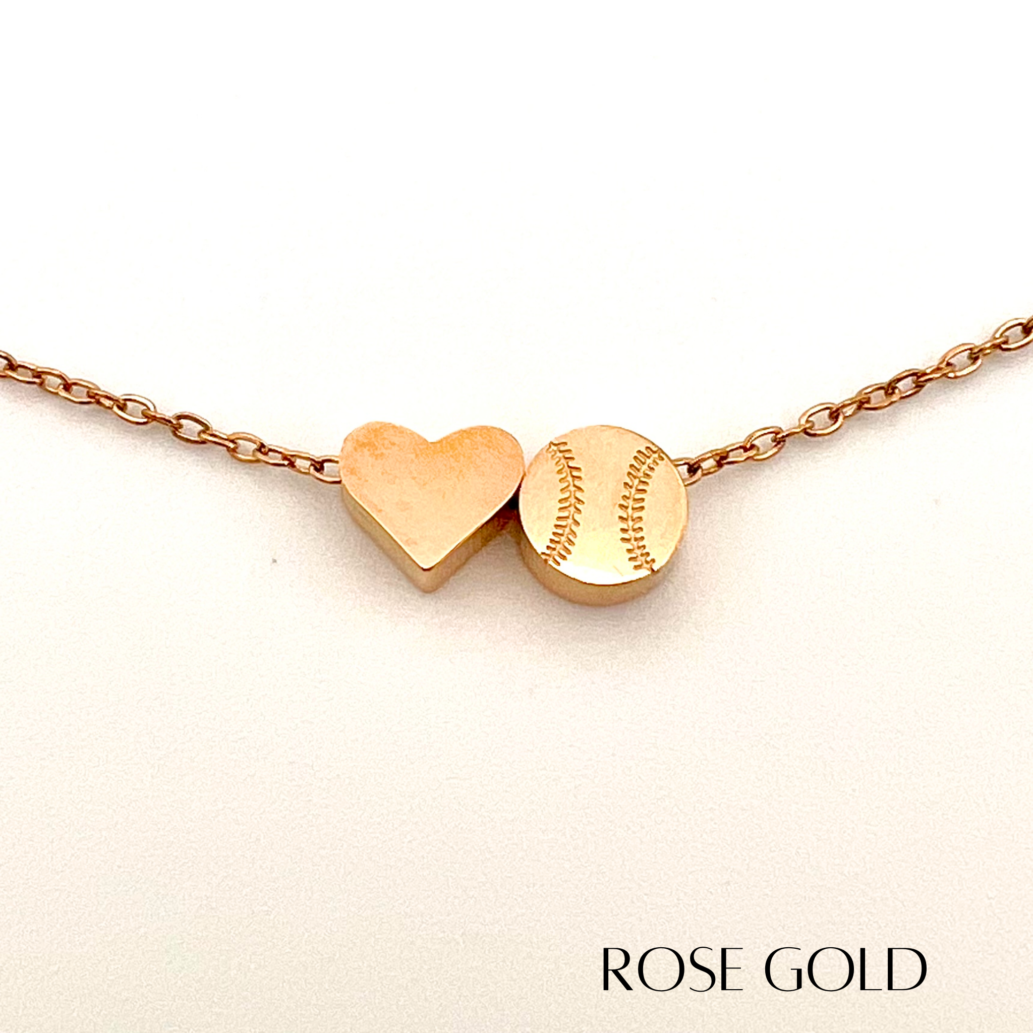 Product close up picture for the Heart and Baseball charm necklace in rose gold
